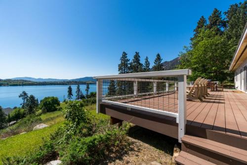 a deck with a view of a lake at Blue Lake Serenity in Hollywood Beach