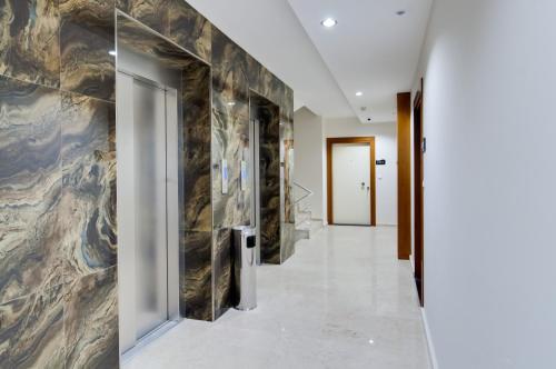 a hallway in a building with a stone wall at Upart Home in Mersin