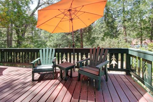 two chairs and an umbrella on a wooden deck at The Crow's Nest in Idyllwild