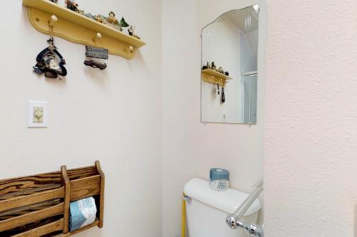 a bathroom with a toilet and a shelf on the wall at Foxtail Delight in Dora Belle