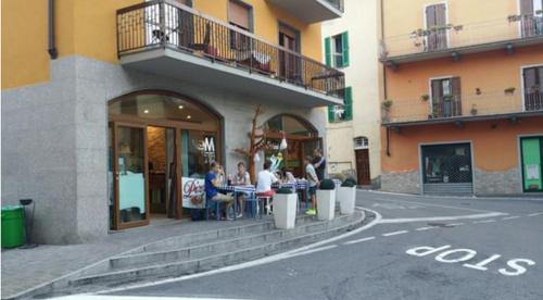 a group of people sitting at a table outside of a building at Casa Tiziana in Sovere