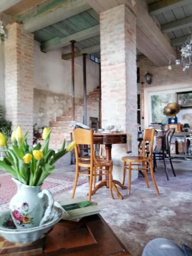 a dining room with a table and chairs and a vase with flowers at Vila Terrasse in Košice