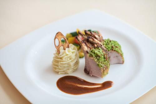 a plate with some food on a white plate at Hotel Zum Mohren in Resia