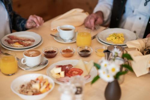 a table with plates of breakfast foods and drinks at Hotel Zum Mohren in Resia