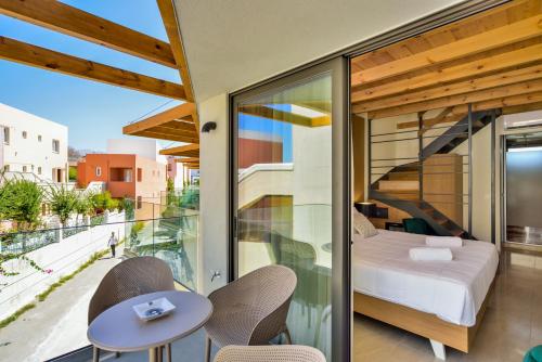 a bedroom with a bed and a balcony at Elia Agia Marina Hotel in Agia Marina Nea Kydonias