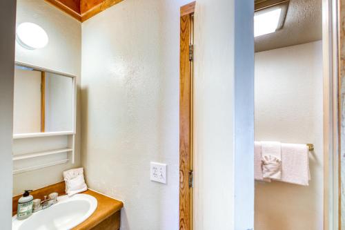a bathroom with a sink and a mirror at Treehouse 206F in Silverthorne