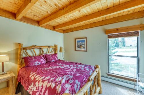 a bedroom with a bed and a window at Treehouse 206F in Silverthorne
