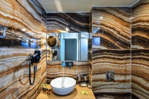 a bathroom with a sink and a mirror at Elia Agia Marina Hotel in Agia Marina Nea Kydonias