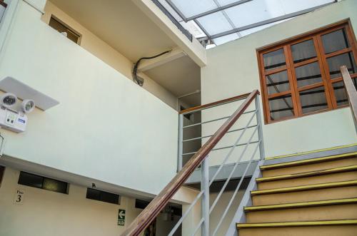 a staircase in a building with a skylight at Inkawasi Miraflores Hostel in Lima