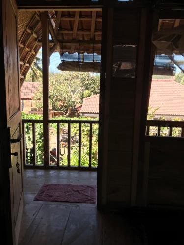 an open door to a room with a balcony at Harry's Ocean House Pacitan in Pacitan