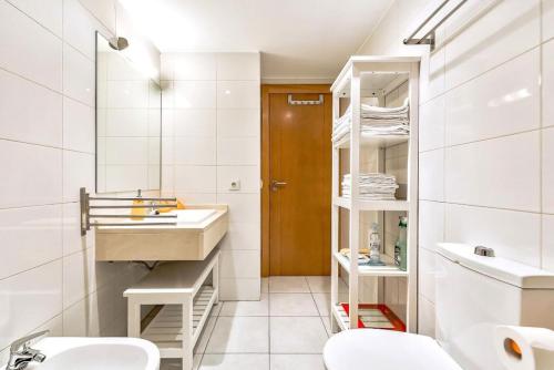 a bathroom with a sink and two toilets at Oasis Fañabe Townhouse in Adeje