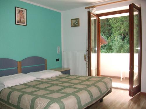 Postel nebo postele na pokoji v ubytování Hotel Genzianella