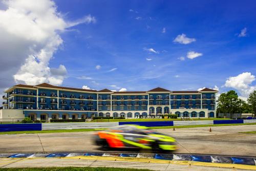 a person riding a motorcycle in front of a building at SEVEN Sebring Raceway Hotel in Sebring