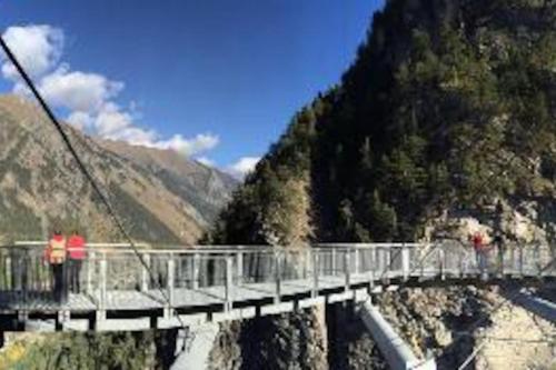 a bridge over a river on a mountain at La Maison Everest 73 - bilocale a La Ruine, Morgex in Morgex