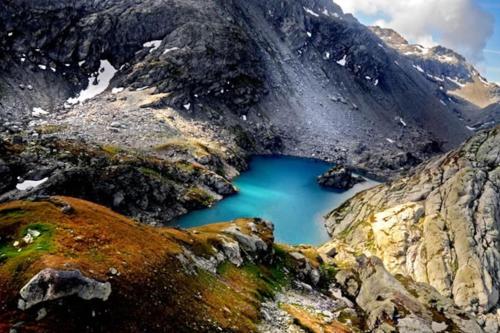 a blue lake in the middle of a mountain at La Maison Everest 73 - bilocale a La Ruine, Morgex in Morgex