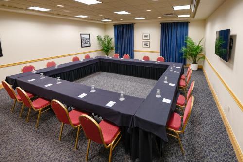a conference room with a large table and chairs at SEVEN Sebring Raceway Hotel in Sebring