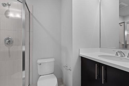 a bathroom with a toilet and a sink and a shower at Global Luxury Suites at The White House in Washington