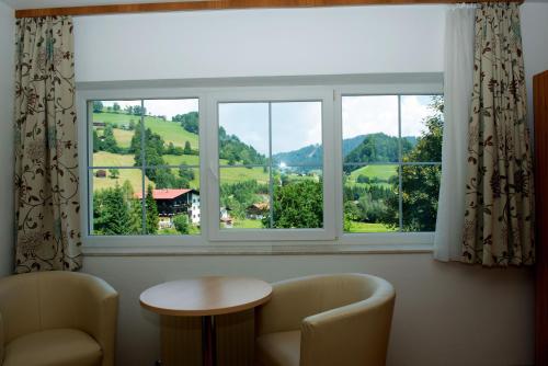 a window in a room with a table and chairs at Vicky Apartments in Niederau