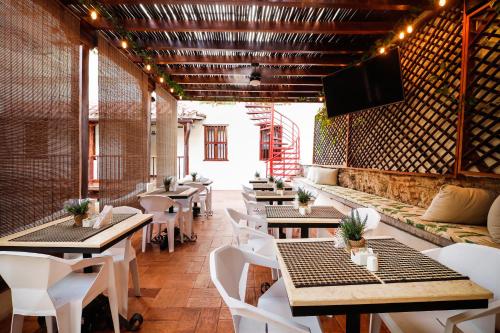 a restaurant with tables and chairs and a flat screen tv at Casa BuGo in Cartagena de Indias