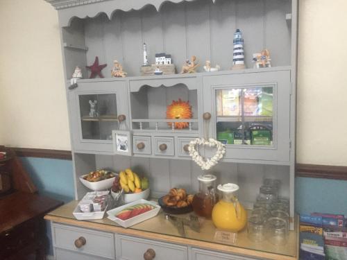a kitchen cabinet with fruits and vegetables in it at The Beaches in Scarborough