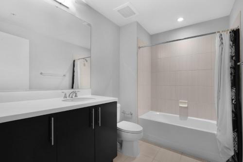 a bathroom with a toilet and a sink and a bath tub at Global Luxury Suites at The White House in Washington