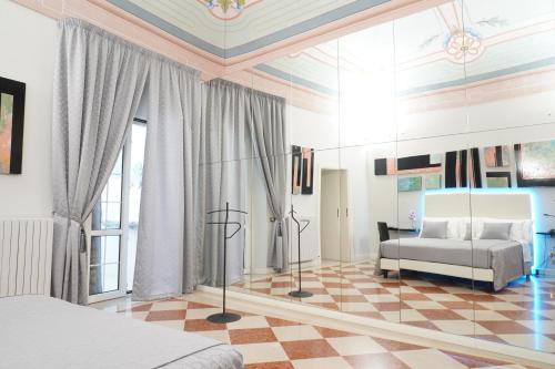 a bedroom with a bed and a checkerboard floor at Rosita Luxury Apartments in Apricena