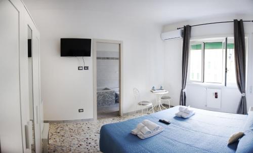 a bedroom with a blue bed and a mirror at Ostiense District B&B in Rome