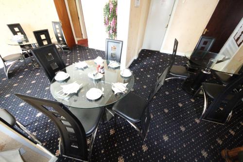 uma sala de jantar com mesa e cadeiras em Avalon Guest House em Leeds