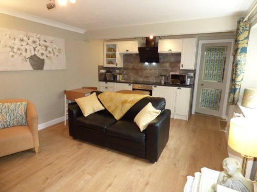 a living room with a couch and a kitchen at No6 @ Globe Lane,Alston in Alston