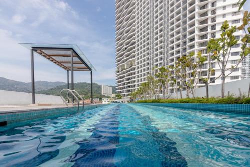 a swimming pool in front of two tall buildings at The Landmark Condo, by Sanguine in George Town