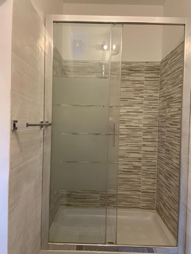 a shower with a glass door in a bathroom at House S&D in Giarre