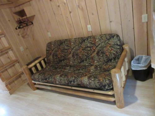 a couch sitting in a corner of a room at Chateau Tina in the Catskill Mountains in East Durham