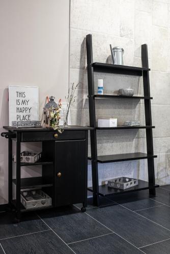 a black desk and a shelf with a sign on it at Hotel Kostelski Buk in Bihać