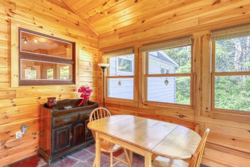 a dining room with a table and a wooden wall at Adirondack Adventuring in Brant Lake