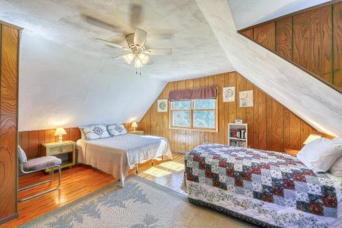 a bedroom with two beds and a ceiling fan at Adirondack Adventuring in Brant Lake