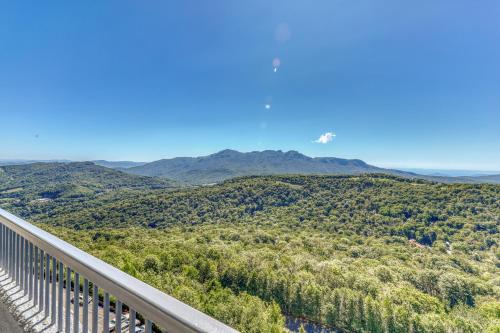 a helicopter flies over a valley with mountains at Sugar Top 2816 in Sugar Mountain