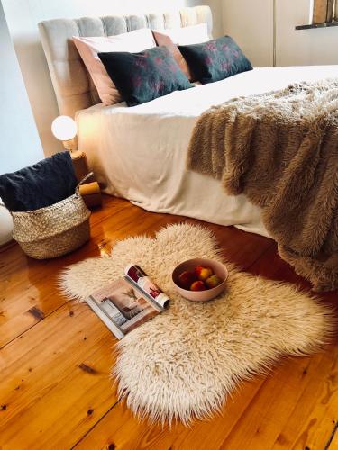 a bedroom with a bed and a rug on the floor at Sielanka w Brennej in Brenna