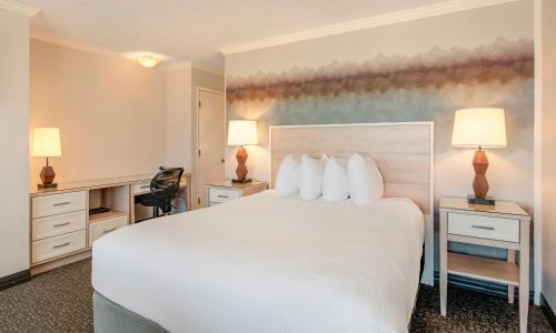 a hotel room with a white bed and two lamps at Hallmark Resort in Cannon Beach in Cannon Beach