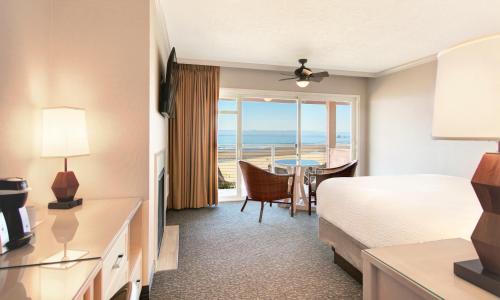 a hotel room with a bed and a view of the ocean at Hallmark Resort in Cannon Beach in Cannon Beach