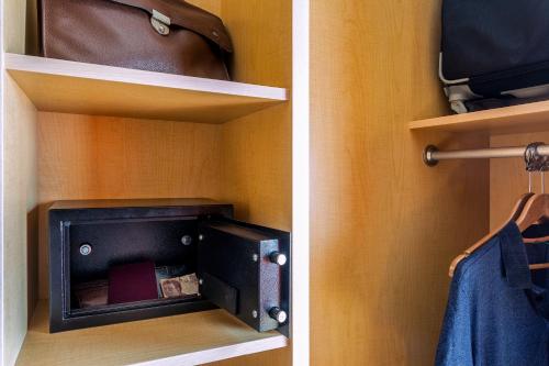a closet with a book shelf with a box on it at Ibis Cancun Centro in Cancún