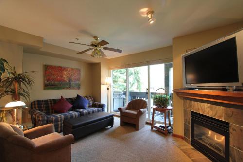 a living room with a television and a fireplace at Lagoons Condos by Whistler Retreats in Whistler