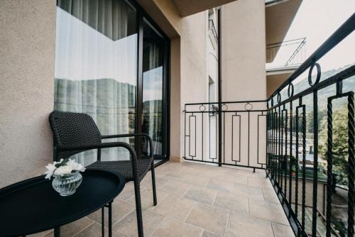 a balcony with a table and chairs on a balcony at Hotel Kostelski Buk in Bihać