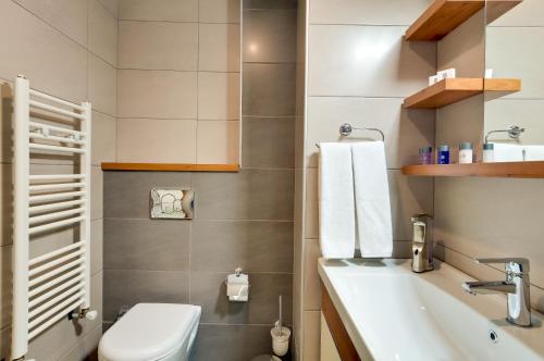 a bathroom with a toilet and a sink at Upart Home in Mersin
