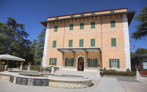 a large building with two fountains in front of it at Hotel Villa Verdefiore in Appignano