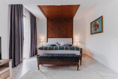 a bedroom with a bed and a large window at Hotel Kostelski Buk in Bihać