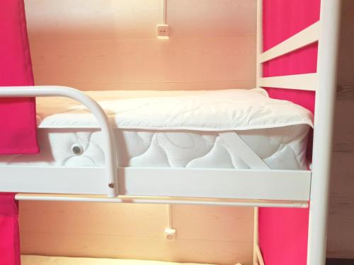 a bunk bed in a room with pink walls at Hostel 777 Vokzal in Kyiv