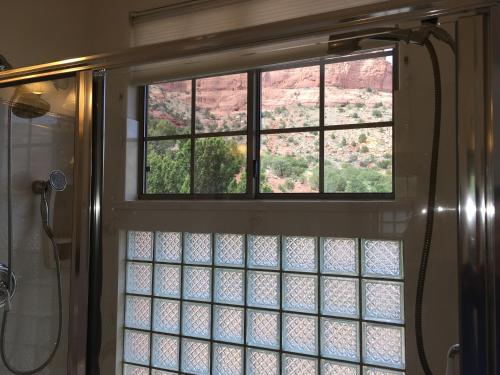 a bathroom with a shower with a window at The Penrose Bed & Breakfast in Sedona