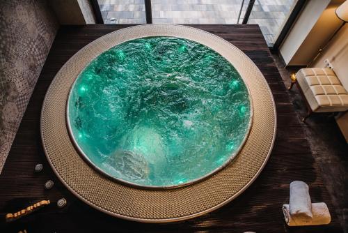 a large pool of green water sitting on top of a table at Hotel Kostelski Buk in Bihać