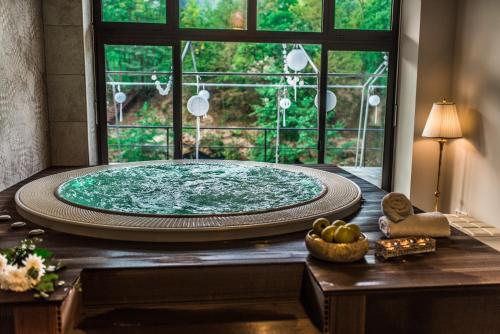 a large bath tub in a room with a window at Hotel Kostelski Buk in Bihać