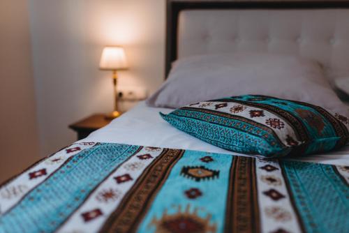 a bed with two pillows on top of it at Hotel Kostelski Buk in Bihać